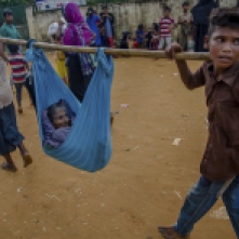 A Rohingya Muslim woman Lalmoti is carried to hospital by her son and grandson in Kutupalong refugee camp, Bangladesh, Monday, Sept. 18, 2017. Bangladesh has been overwhelmed with more than 400,000 Rohingya who fled their homes in the last three weeks amid a crisis the U.N. describes as ethnic cleansing. Refugee camps were already beyond capacity and new arrivals were staying in schools or huddling in makeshift settlements with no toilets along roadsides and in open fields. (Photo: Dar Yasin/ AP)
